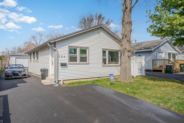 324 N Prospect Dr, Round Lake Park, IL 60073 - view of front of home with an outdoor structure, a front yard, crawl space, and asphalt driveway