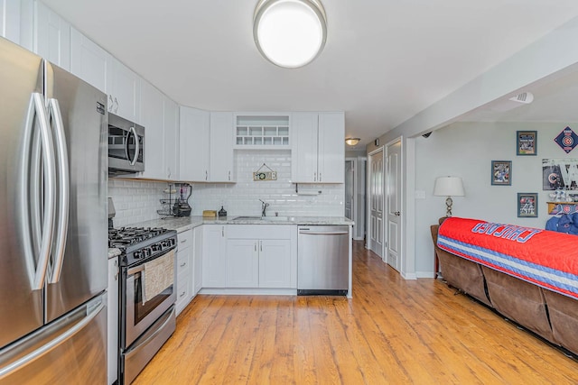 324 N Prospect Dr, Round Lake Park, IL 60073 - kitchen with stainless steel appliances, white cabinets, light stone countertops, and tasteful backsplash