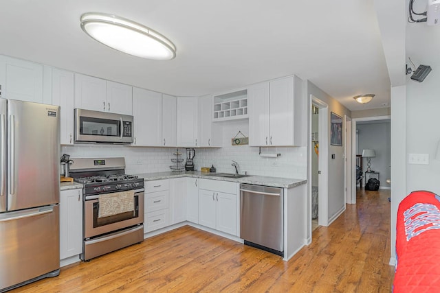324 N Prospect Dr, Round Lake Park, IL 60073 - kitchen featuring stainless steel appliances, backsplash, light stone counters, white cabinets, and open shelves