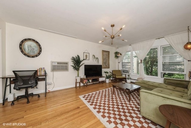 4030 N Mozart St Unit 3N, Chicago, IL 60618 - living area featuring light wood-style floors, a chandelier, a wall unit AC, and a desk