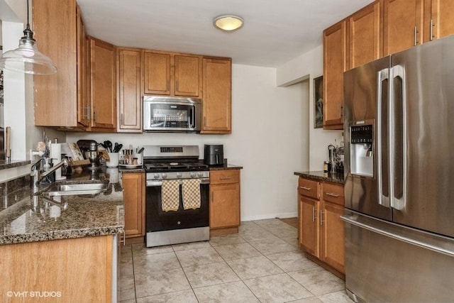 4030 N Mozart St Unit 3N, Chicago, IL 60618 - kitchen featuring appliances with stainless steel finishes, brown cabinets, dark stone counters, and light tile patterned flooring