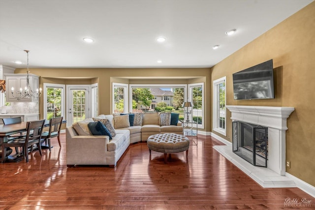 0S400 Crego Pl, Geneva, IL 60134 - living area with a fireplace with raised hearth, hardwood / wood-style floors, a chandelier, and recessed lighting