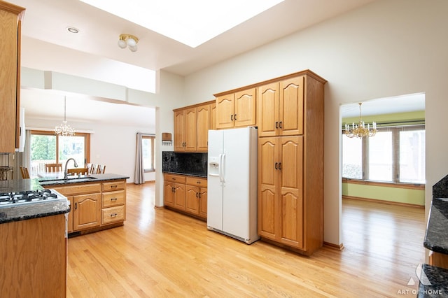 1196 Covington Dr, Lemont, IL 60439 - kitchen featuring white fridge with ice dispenser, a chandelier, light wood-type flooring, backsplash, and a high ceiling