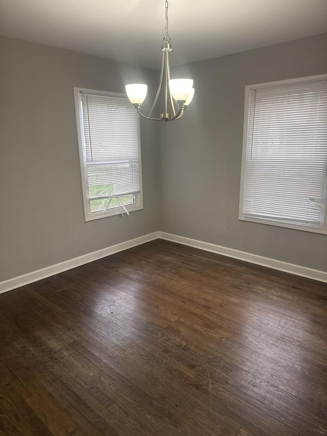 15818 Saint Louis Ave, Markham, IL 60428 - unfurnished room with a chandelier and dark wood finished floors