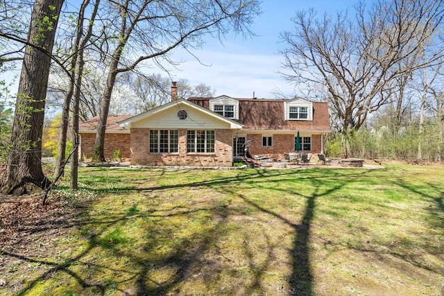 125 Grove Ln, Barrington, IL 60010 - back of property featuring brick siding, a chimney, a lawn, and a patio