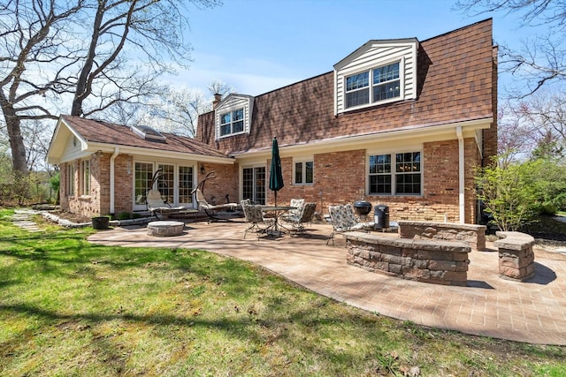 125 Grove Ln, Barrington, IL 60010 - back of property featuring a patio area, brick siding, an outdoor fire pit, and a lawn