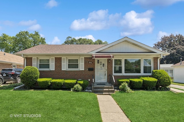 8411 Mansfield Ave, Morton Grove, IL 60053 - view of front facade with brick siding and a front lawn