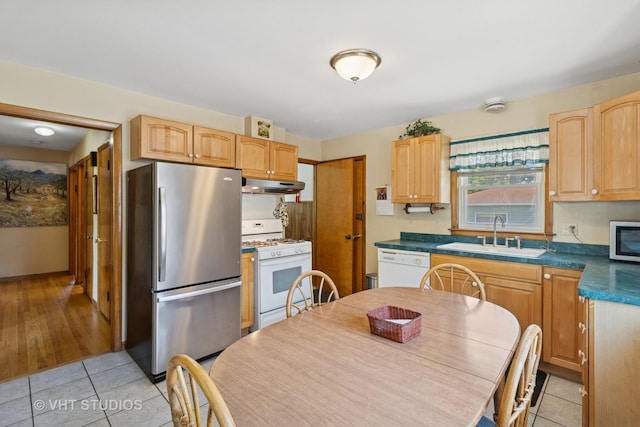 8411 Mansfield Ave, Morton Grove, IL 60053 - kitchen featuring stainless steel appliances, under cabinet range hood, light tile patterned floors, and dark countertops