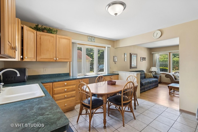 8411 Mansfield Ave, Morton Grove, IL 60053 - kitchen featuring dark countertops, light tile patterned floors, and open floor plan