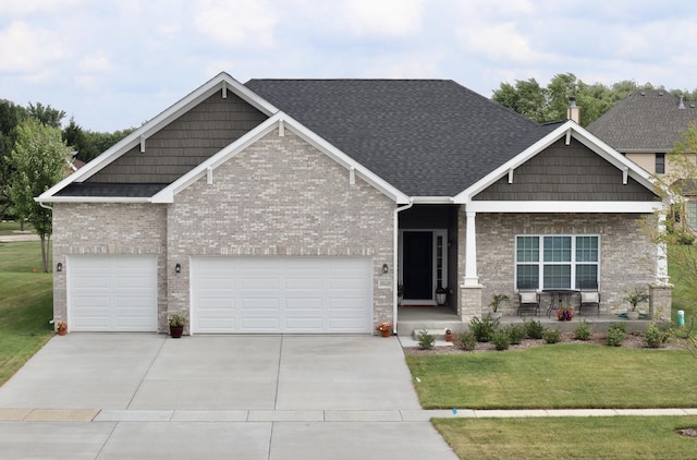 26824 W Old Kerry, Channahon, IL 60410 - craftsman inspired home with covered porch, a front yard, concrete driveway, roof with shingles, and brick siding