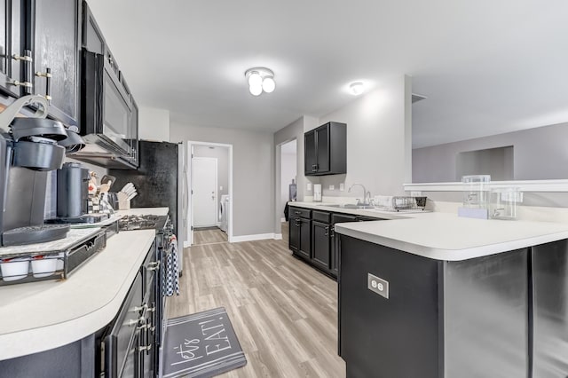 739 Glen Cove Ln, Pingree Grove, IL 60140 - kitchen featuring a peninsula, stainless steel microwave, light wood-type flooring, light countertops, and gas stove