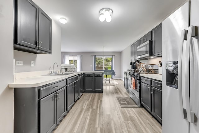 739 Glen Cove Ln, Pingree Grove, IL 60140 - kitchen with appliances with stainless steel finishes, a peninsula, light wood-type flooring, and light countertops