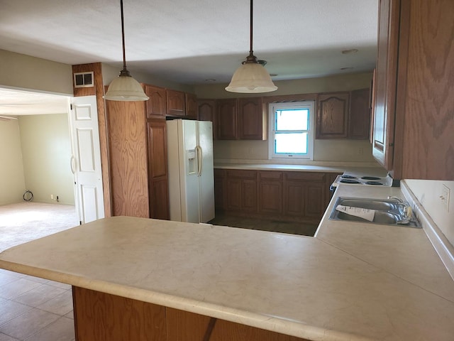 67 S Somonauk Rd, Cortland, IL 60112 - kitchen featuring white refrigerator with ice dispenser, a peninsula, light countertops, and hanging light fixtures