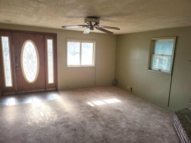 67 S Somonauk Rd, Cortland, IL 60112 - carpeted entryway featuring healthy amount of natural light, a ceiling fan, and a textured ceiling