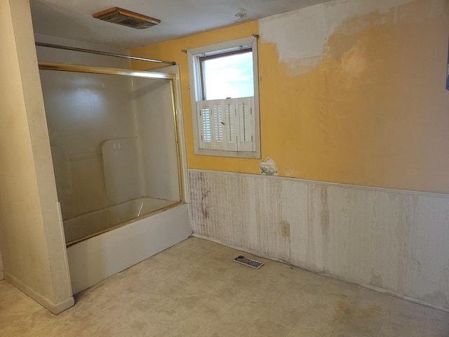 67 S Somonauk Rd, Cortland, IL 60112 - bathroom with a wainscoted wall, shower / bath combination with glass door, and tile patterned floors