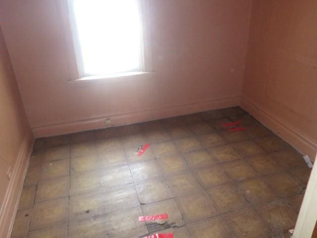 6527 S Marshfield Ave, Chicago, IL 60636 - empty room with baseboards and tile patterned flooring