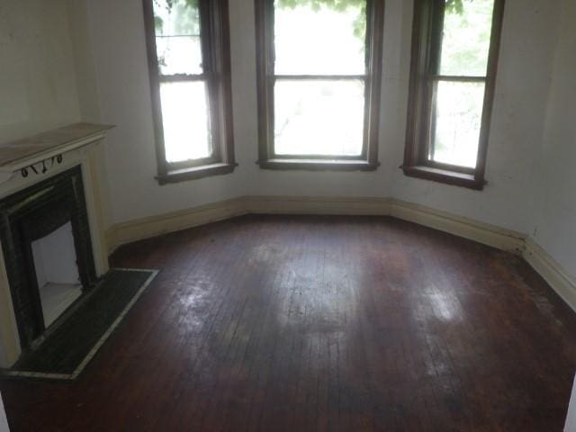 6527 S Marshfield Ave, Chicago, IL 60636 - unfurnished living room with dark wood-style flooring, plenty of natural light, and a fireplace