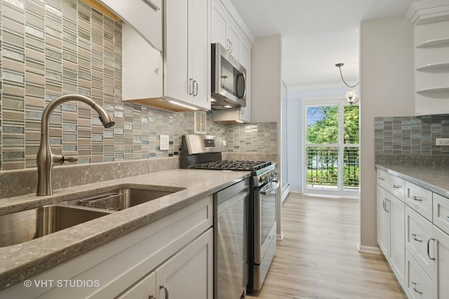 1127 S Old Wilke Rd Unit 201, Arlington Heights, IL 60005 - kitchen featuring appliances with stainless steel finishes, white cabinetry, decorative backsplash, light wood-type flooring, and light stone counters
