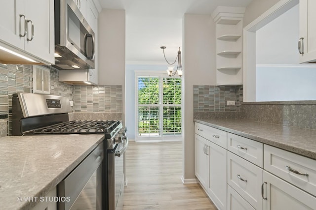 1127 S Old Wilke Rd Unit 201, Arlington Heights, IL 60005 - kitchen featuring appliances with stainless steel finishes, open shelves, light wood finished floors, white cabinetry, and crown molding