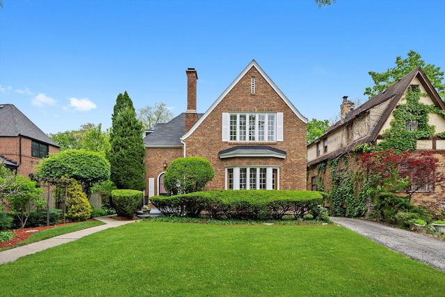 9209 S Hoyne Ave, Chicago, IL 60643 - tudor house with a front yard, brick siding, and a chimney