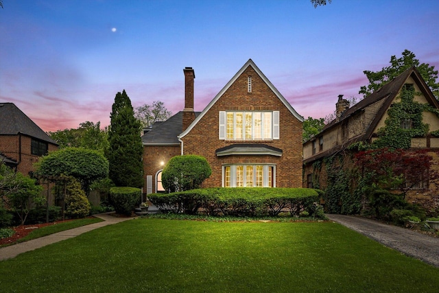9209 S Hoyne Ave, Chicago, IL 60643 - tudor house featuring a front lawn, brick siding, and a chimney
