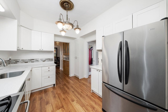 9209 S Hoyne Ave, Chicago, IL 60643 - kitchen with freestanding refrigerator, white cabinetry, tasteful backsplash, and light wood finished floors