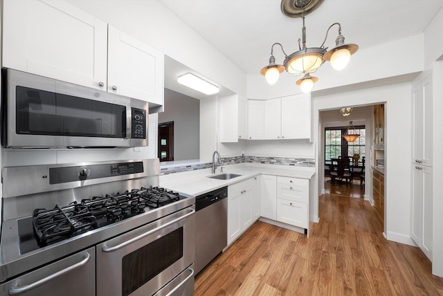 9209 S Hoyne Ave, Chicago, IL 60643 - kitchen with appliances with stainless steel finishes, light countertops, light wood-style flooring, and white cabinetry