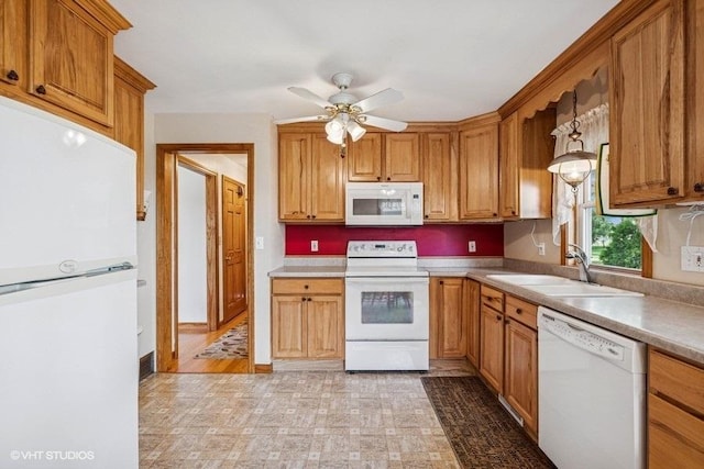 12501 Hebron Rd, Hebron, IL 60034 - kitchen with white appliances, ceiling fan, light countertops, and brown cabinets