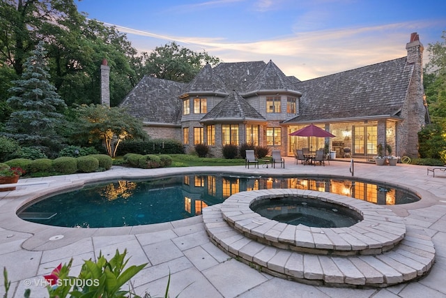 33W551 Hub Rd, Wayne, IL 60184 - pool at dusk with a patio, an outdoor pool, an in-ground hot tub, and outdoor dining area