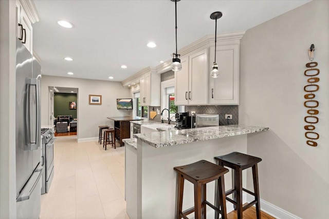 1738 E Jonquil Ter, Arlington Heights, IL 60004 - kitchen with stainless steel appliances, a peninsula, light stone countertops, a breakfast bar area, and recessed lighting
