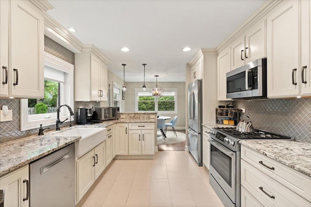 1738 E Jonquil Ter, Arlington Heights, IL 60004 - kitchen featuring stainless steel appliances, healthy amount of natural light, backsplash, decorative light fixtures, and recessed lighting