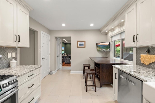 1738 E Jonquil Ter, Arlington Heights, IL 60004 - kitchen featuring stainless steel appliances, decorative backsplash, recessed lighting, and light stone countertops