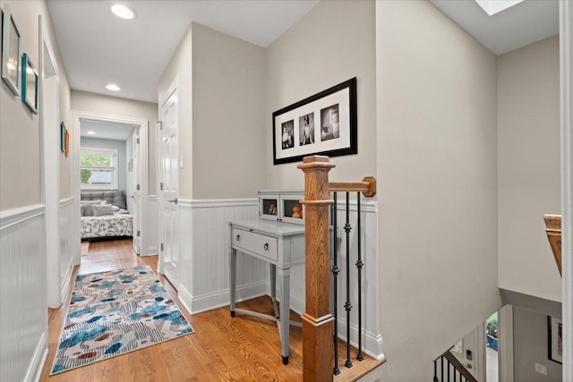 1738 E Jonquil Ter, Arlington Heights, IL 60004 - hall featuring light wood finished floors, wainscoting, an upstairs landing, a skylight, and recessed lighting