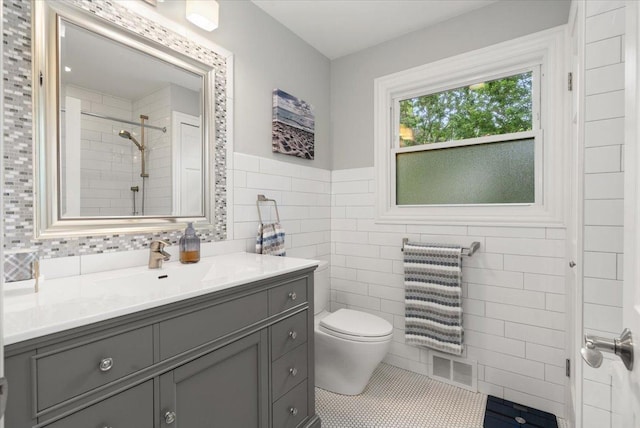 1738 E Jonquil Ter, Arlington Heights, IL 60004 - full bathroom featuring tile walls, vanity, tile patterned floors, tiled shower, and a wainscoted wall