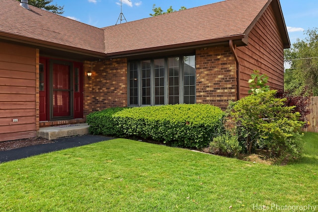 1506 Wilson Ct, Zion, IL 60099 - property entrance featuring brick siding, a lawn, and roof with shingles