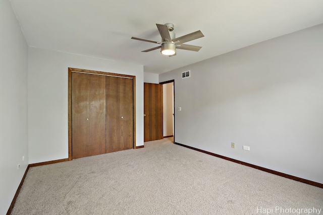 1506 Wilson Ct, Zion, IL 60099 - unfurnished bedroom featuring a closet, light colored carpet, and ceiling fan
