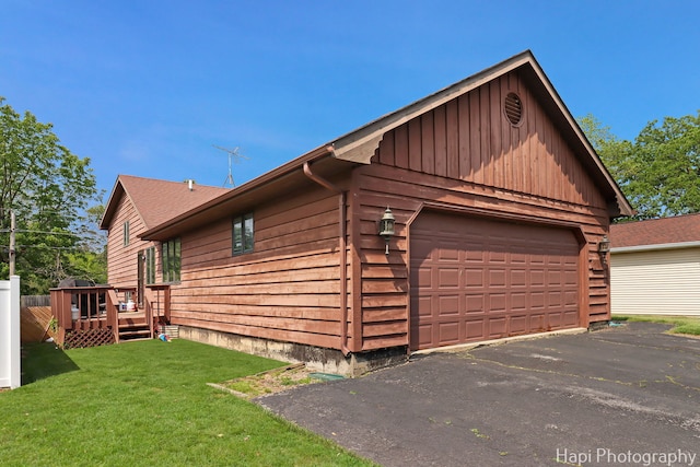 1506 Wilson Ct, Zion, IL 60099 - view of home's exterior with board and batten siding, a deck, a detached garage, and a lawn