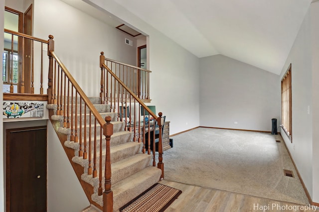 1506 Wilson Ct, Zion, IL 60099 - stairs featuring lofted ceiling, wood finished floors, and carpet floors