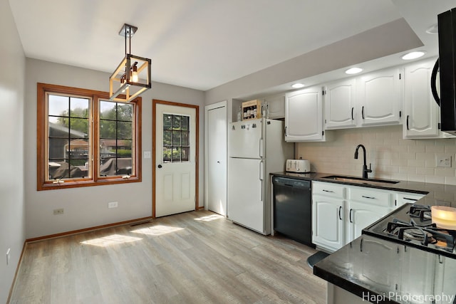 1506 Wilson Ct, Zion, IL 60099 - kitchen with black dishwasher, freestanding refrigerator, dark countertops, backsplash, and recessed lighting