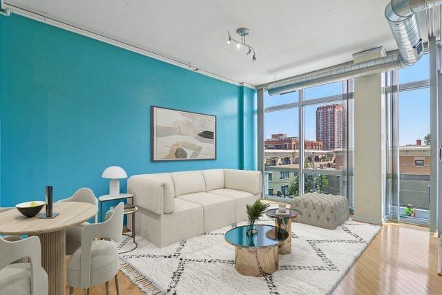 1819 S Michigan Ave Unit 406, Chicago, IL 60616 - living room with expansive windows, wood finished floors, and a city view