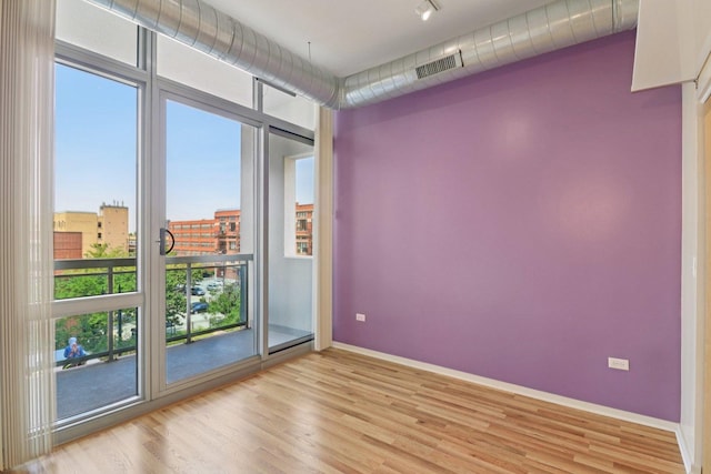 1819 S Michigan Ave Unit 406, Chicago, IL 60616 - spare room with light wood-style flooring and rail lighting
