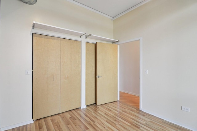 1819 S Michigan Ave Unit 406, Chicago, IL 60616 - unfurnished bedroom with ornamental molding, light wood-style floors, and two closets