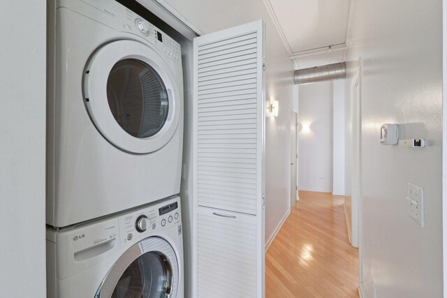 1819 S Michigan Ave Unit 406, Chicago, IL 60616 - washroom featuring estacked washer and dryer and light wood-style floors
