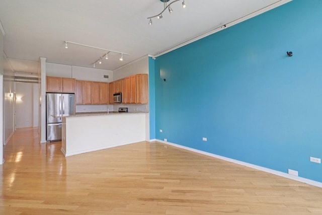1819 S Michigan Ave Unit 406, Chicago, IL 60616 - kitchen featuring appliances with stainless steel finishes, track lighting, and light wood-style floors