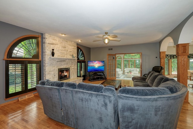 1315 Keim Trl, Saint Charles, IL 60174 - living room with arched walkways, a stone fireplace, ceiling fan, and wood finished floors
