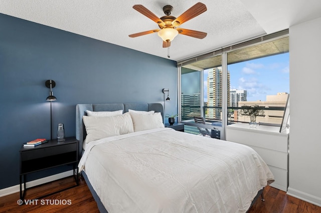800 Elgin Rd Unit 1316, Evanston, IL 60201 - bedroom with wood finished floors, expansive windows, a textured ceiling, a view of city, and ceiling fan