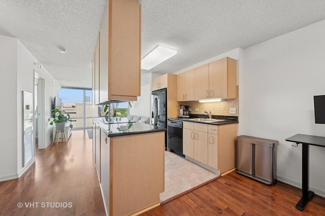 800 Elgin Rd Unit 1316, Evanston, IL 60201 - kitchen with black dishwasher, light brown cabinetry, dark countertops, wood finished floors, and a textured ceiling