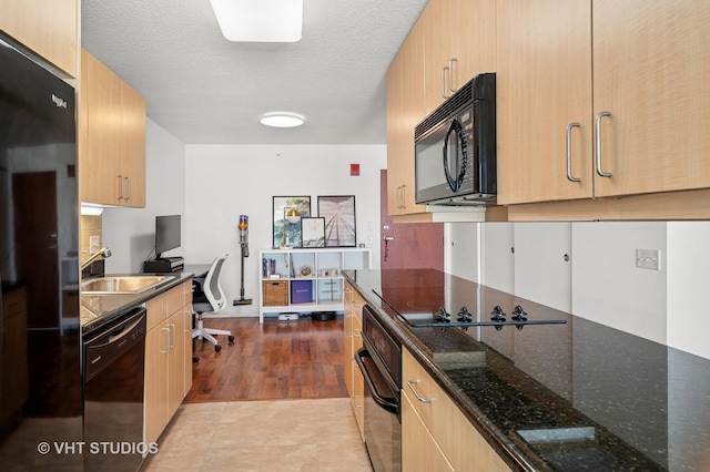 800 Elgin Rd Unit 1316, Evanston, IL 60201 - kitchen with black appliances, an office area, light brown cabinetry, dark stone countertops, and a textured ceiling
