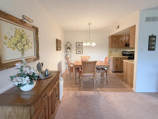 8025 Woodglen Ln Unit 307, Downers Grove, IL 60516 - dining space featuring light carpet, a chandelier, and a textured ceiling