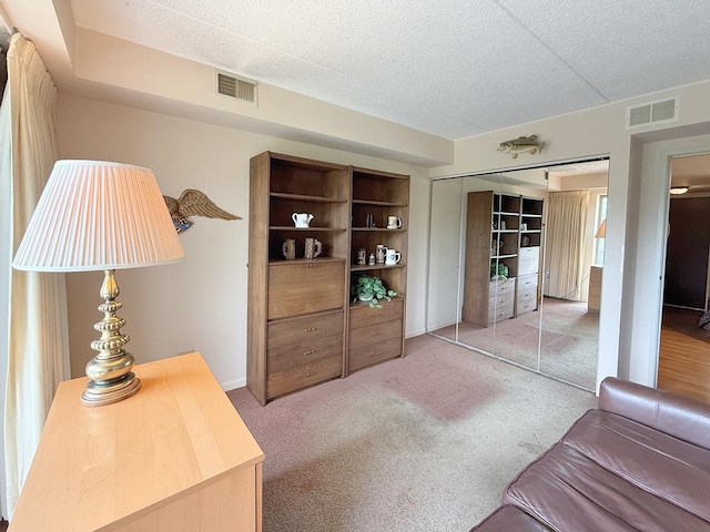 8025 Woodglen Ln Unit 307, Downers Grove, IL 60516 - bedroom featuring carpet floors, a closet, and a textured ceiling